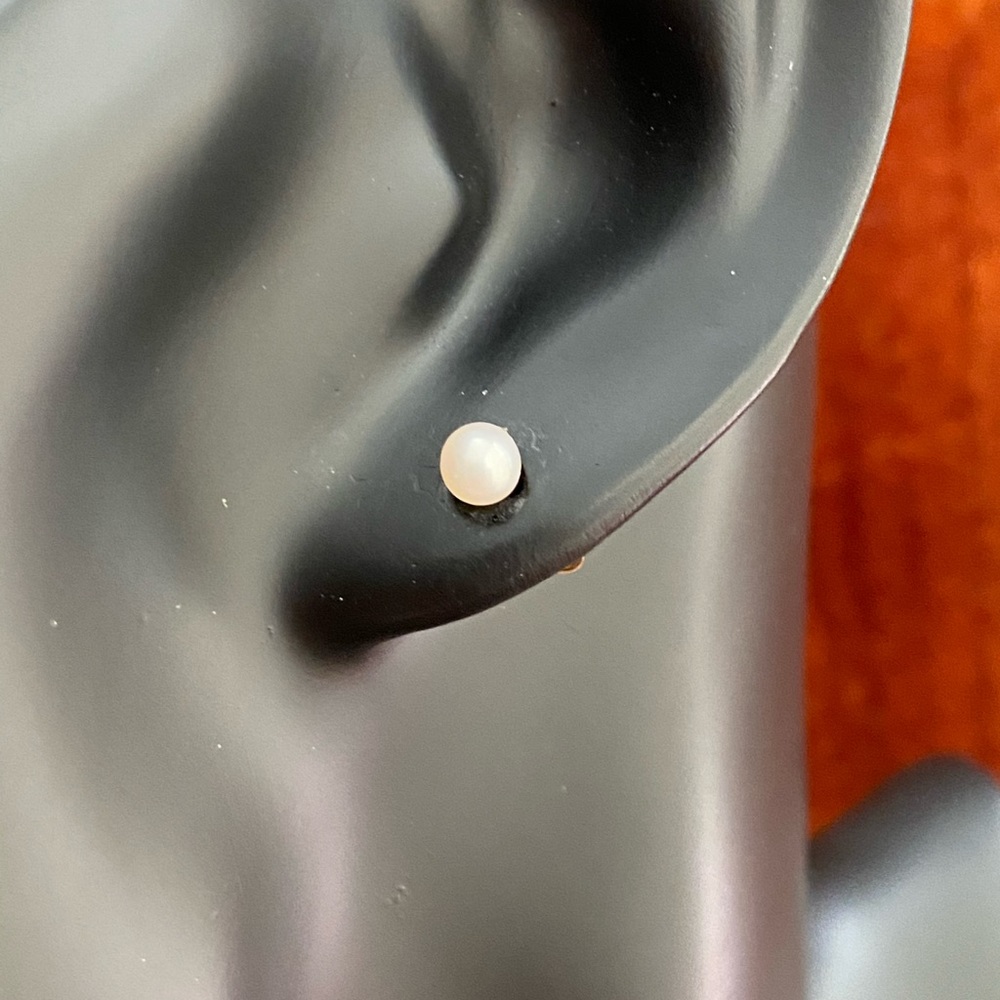 4mm white pearl pierced earrings on 14 kt. yellow gold post.
